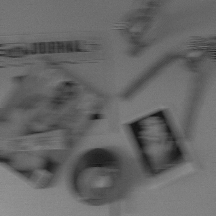 Blurred black-and-white wall collage with photos and a round clock.
