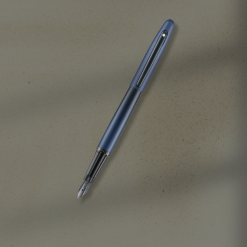 Blue fountain pen with silver nib resting diagonally on a beige textured surface.