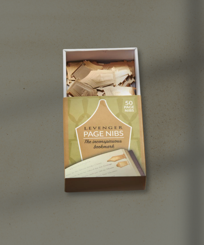 Open box of LeVenger Page Nibs on a gray surface, with small paper slips inside the box.