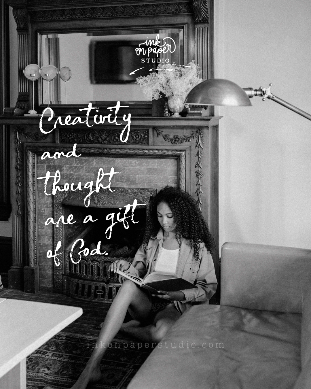 A woman sits by a fireplace reading a book, with handwritten quote over the image: 'Creativity and thought are a gift of God.' in white script.