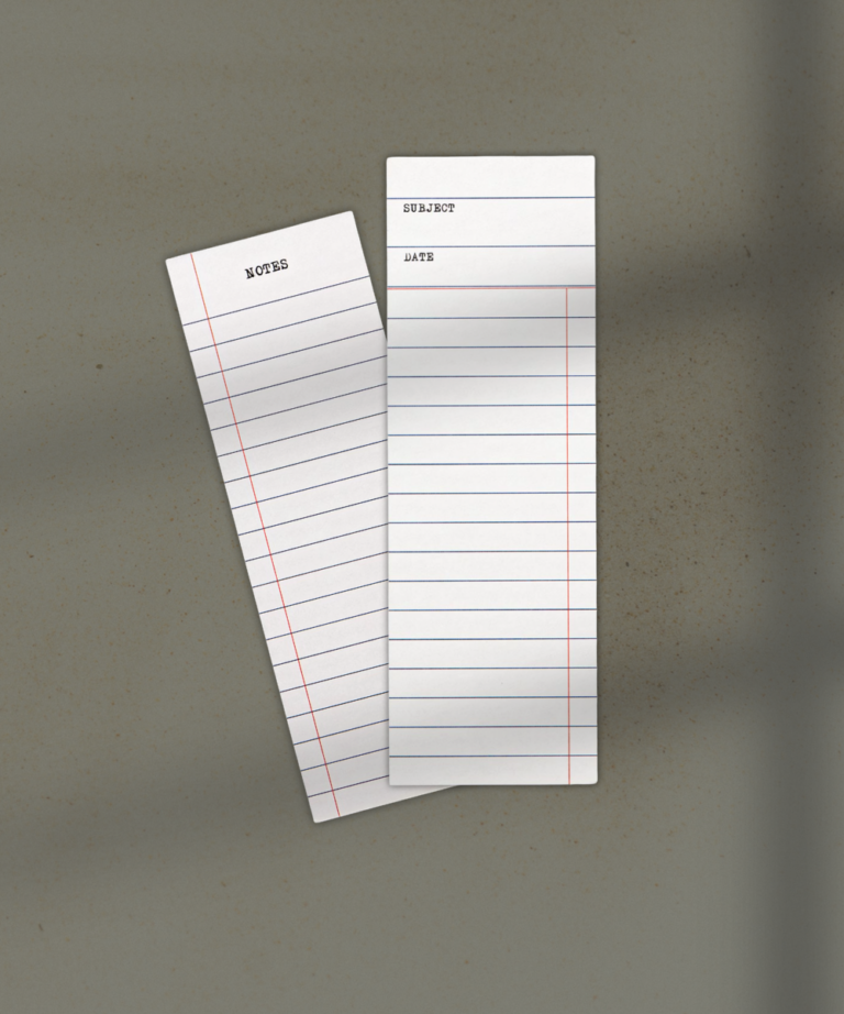 Two white index cards with ruled lines, one labeled NOTES and the other showing SUBJECT and DATE, overlapping on a beige surface.