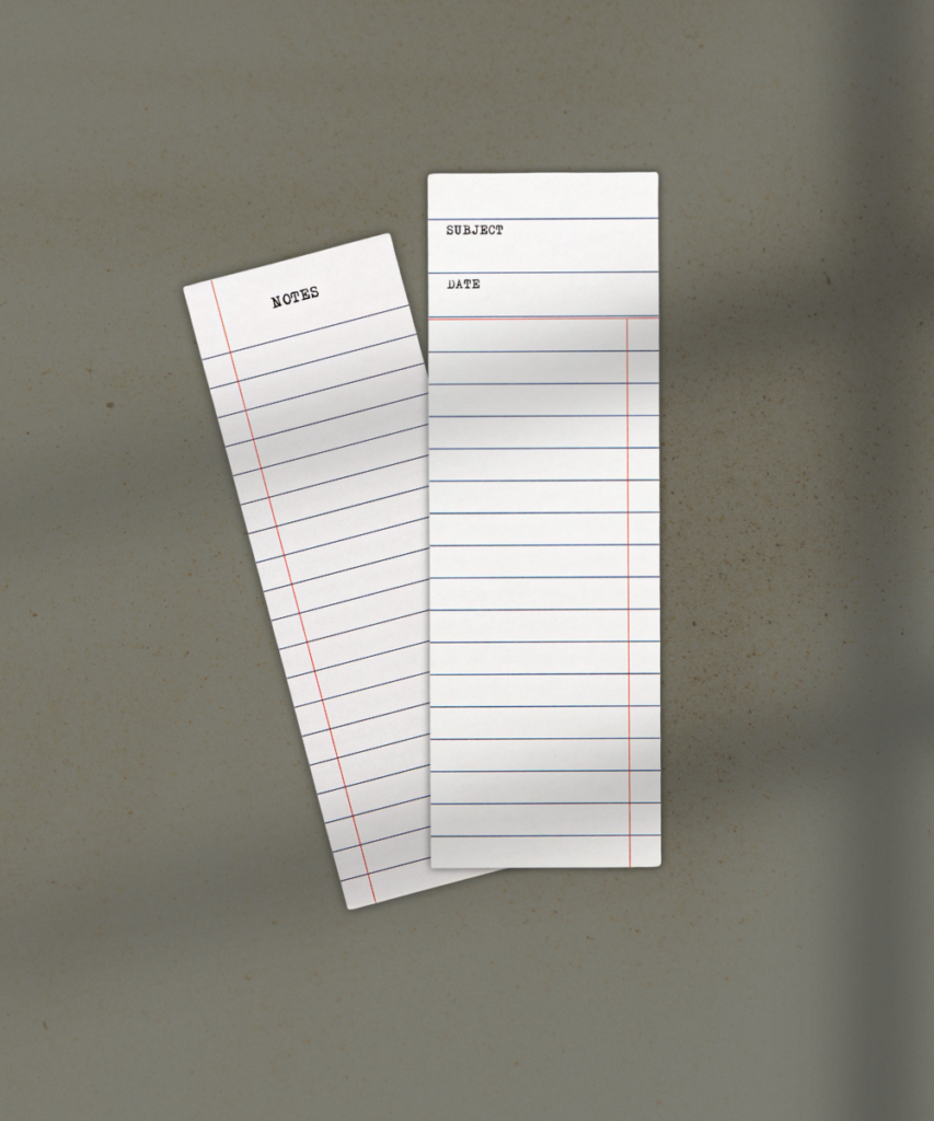 Two white index cards with ruled lines, one labeled NOTES and the other showing SUBJECT and DATE, overlapping on a beige surface.
