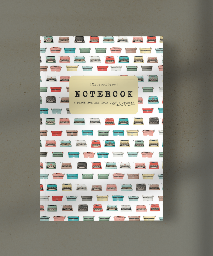 Notebook cover with a pattern of colorful vintage typewriters and a beige label reading NOTEBOOK.
